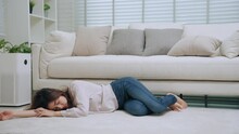 Young Asian Woman Sick Feeling Dizzy And Faint Falling Down Lose Consciousness On Floor Front Of Sofa In Living Room At Home. Healthcare And Medical Concept