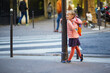preschooler girl with school backpack having fun on a street on a fall day