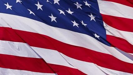 Wall Mural - close up of the us flag blowing in the breeze.