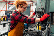 © DusanJelicic - A young woman in STEM adjusts a machine with a drill before starting work on a new project, uses protective equipment and practices safe work