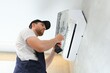 © Serhii - Service man is cleaning, repair and maintenance of air conditioner.