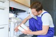 © Serhii - Young plumber or technician installing or repairing system of water filtration