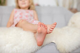 Fototapeta  - Cute sweet toddler children, tickling feet on the bed, laughing and smiling