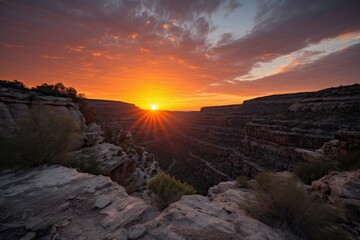 Wall Mural - fiery sunset above canyon, with glimpse of the sun sinking below the horizon, created with generative ai