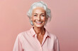 Beautiful elderly fashion model with gray hair on pastel pink background