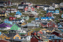Close-up View Of The Colorful Buildings On The Rocky Cliffs Along The Shore In The Seaport Town Of Qaqortoq On Greenland's Southern Tip; Qaqortoq, Southern Greenland, Greenland