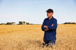 © Designpics - Portrait of a farmer looking at the camera while standing in a fully ripened grain field during the fall harvest; Alcomdale, Alberta, Canada
