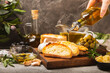 Italian ciabatta bread with olives, garlic, parmesan and rosemary on a dark marble background. Tasty food. Aperitif. Place for text. copy space. Delicacy. Bon appetit.