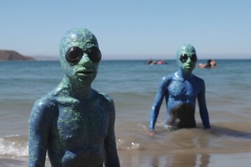 Wall Mural - humorous mockumentary showing aliens at the beach, playing in the waves and swimming, created with generative ai