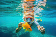 © ADDICTIVE STOCK - A boy diving after an orange fish. Generative AI
