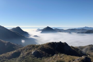 Wall Mural - panoramic view of mist-shrouded mountains, bordered by a blue sky, created with generative ai