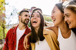 © Xavier Lorenzo - Diverse group of young friends having fun together outdoors in summer. Millennial student people laughing walking in city street enjoying day off. Youth community and friendship concept.