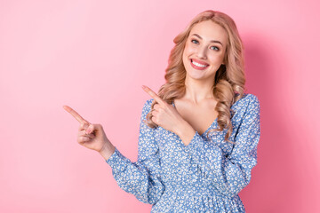 Poster - Photo of stunning cheerful lady beaming smile direct fingers empty space proposition isolated on pink color background