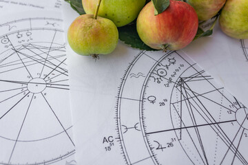 Wall Mural - Printed birth chart with a venus planet and small red apples in the background