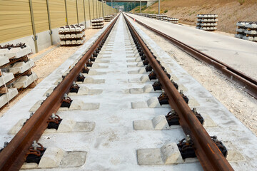 New railroad track. Laying of ICE fast track. Construction site with concrete and steel sleepers. Landscape. Ulm, Wendlingen, A8.