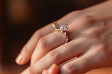 Close Up Of An Elegant Engagement Diamond Ring On Woman Finger. Love And Wedding Concept. Diamond Ring On Young Lady's Hand On Dark Background. High Quality Photo
