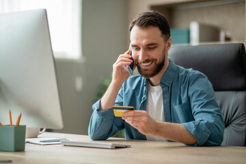 Poster - Mobile Payments. Businessman Holding Credit Card And Talking On Cellphone In Office