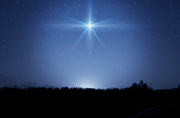 christmas star. background of the beautiful nite dark starry sky and bright star. nativity of bethle