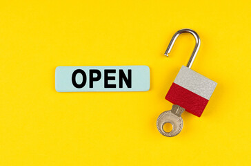 Aufkleber - On the yellow surface is an open lock with a key and a sticker with the inscription - open