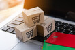 © Achira22 - Shopping online. Credit card and cardboard box with a shopping cart logo on laptop keyboard. Shopping service on The online web. offers home delivery