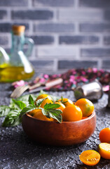 Wall Mural - Fresh ripe yellow tomatoes on dark table outdoors, closeup