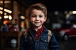 portrait of smiling little boy in denim jacket at barbershop