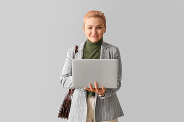 Sticker - Female student using laptop on light background