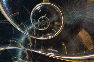 A retro analog clock spiraling into itself. Twisted watch dial. Time managment