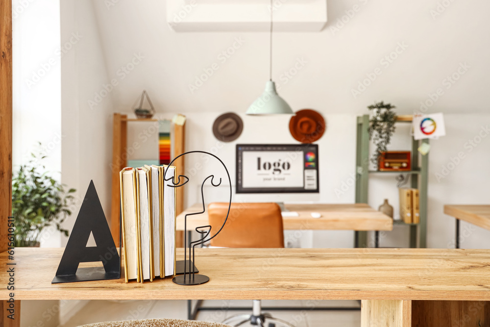 Bookend on table in graphic designer's office, closeup