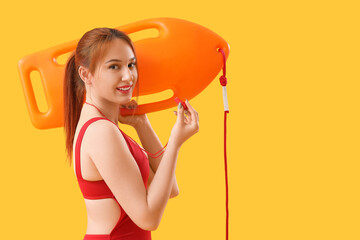 Wall Mural - Female lifeguard with whistle and rescue buoy on yellow background