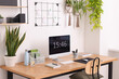 © New Africa - Cozy workplace with computer, modern furniture and houseplants at home