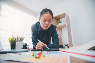 Fototapete - Graphic designer architects who work with laptops and color comparison tables for design work..