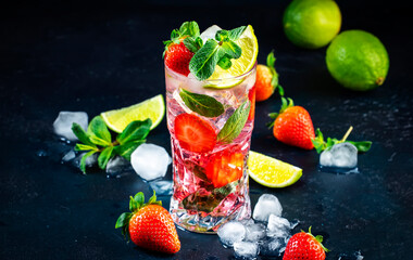 Canvas Print - Summer strawberry mojito cocktail with lime, white rum, soda, cane sugar, mint, and ice in glass on deep blue background. Cold refreshing beverage