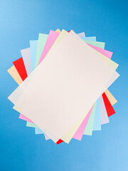 Poster - Colorful paper sheet background  isolated on blue, close up