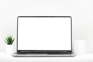 Workspace with table and laptop with blank screen, minimalistic interior, front view
