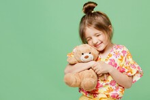 Little Happy Child Kid Girl 6-7 Year Old In Casual Clothes Have Fun Hold Hug Teddy Bear Plush Toy Isolated On Plain Pastel Green Background Studio Portrait Mother's Day Love Family Lifestyle Concept