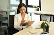 © Prathankarnpap - Charming young businesswoman using digital tablet, searching online information at meeting room