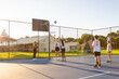 © Austockphoto - children training for netball on outdoor court