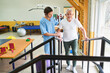 © Robert Kneschke - Physiotherapist assisting elderly man in movement therapy