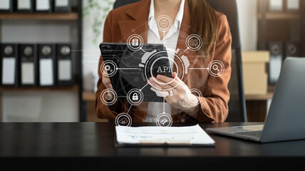 Modern technology and networking concept, woman using laptop, tablet and smartphone with virtual screen API icon Software development tool. API Application Programming Interface.