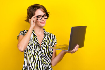 Poster - Photo of optimistic adorable girl bob hairdo dressed zebra print shirt touch eyewear look at laptop isolated on yellow color background