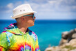 © Luluraschi - A caucasian man enjoying a summer sunny day on a boat at Isla Mujeres Cancun. Colorful clothing. happy young man smiling and waving.