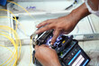 © Kriang - Technician working, fiber optic cable splicing and testing cables with optical power meter