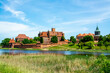 Malbork castle under clear sky during beautiful day with church visibble on the right