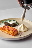 Fototapeta  - Salmon fillet with parmesan espuma, spinach and quinoa in a plate