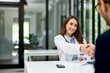 © bnenin - A pretty female doctor handshake with a male patient before an examination.