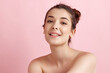 © master1305 - Tender, beautiful young woman with bare shoulders, well-kept, smooth, healthy skin looking at camera over pink background. Concept of natural female beauty, body and skincare, cosmetology, health, ad