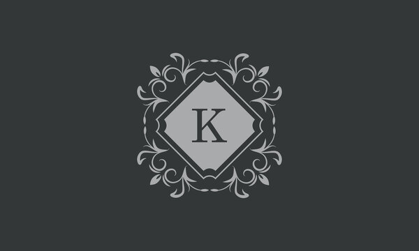 Floral frame with calligraphic elements, letter K. Template for signs, logos, labels, stickers, cards. Graphic design of the page, business.