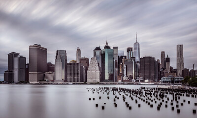 Sticker - dramatic scenery of lower manhattan skyline in the evening on a cloudy day, longterm exposure