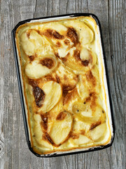 Wall Mural - close up of rustic golden scalloped potato gratin dauphinois